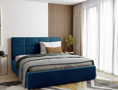 A bedroom scene with a blue upholstered bed.