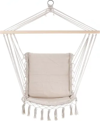A hanging chair with a cushion and tassels, suspended from a wooden bar.
