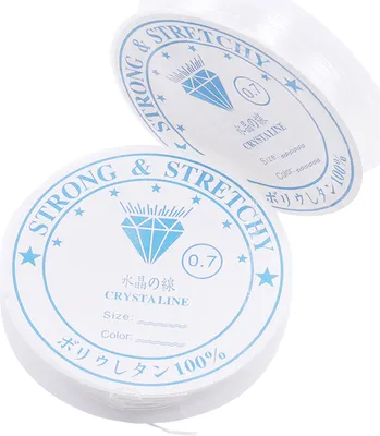 Two spools of clear, stretchy beading cord are shown against a white background. The spools have labels with product information.