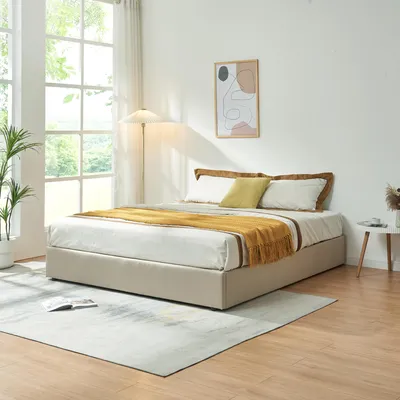 A bedroom scene with a bed, large window, and artwork.