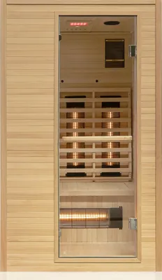 A full-front view of a wooden infrared sauna with a glass door, showing the interior heating elements and control panel.