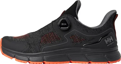 A side view of a black and orange work shoe.