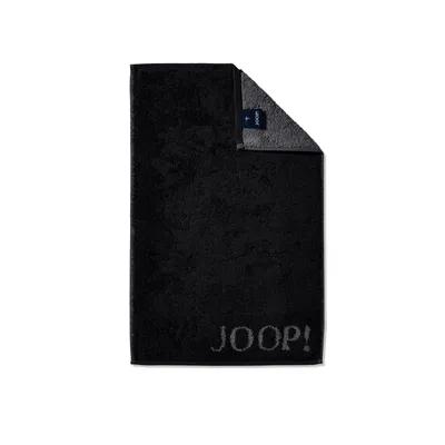 A black JOOP! guest towel folded and lying on a white background.