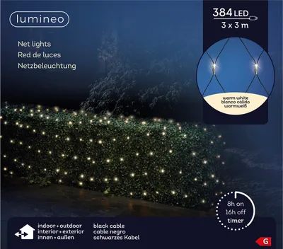 Net lights illuminating a hedge at night.