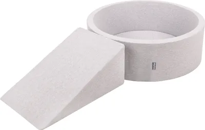 A light gray foam play set consisting of a wedge and a circular pit, shown against a white background.