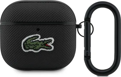 A black AirPods case with a green Lacoste crocodile logo and a black carabiner clip.