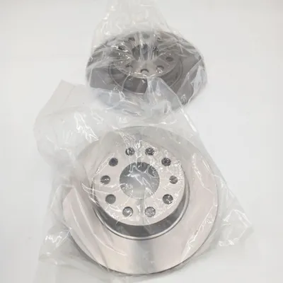 Two brake discs are shown, each individually wrapped in clear plastic, against a white background.