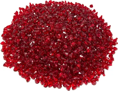 A pile of small, faceted red beads.