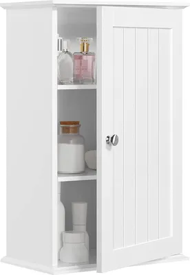 A white bathroom cabinet with its door slightly ajar, revealing shelves with various bottles and jars.