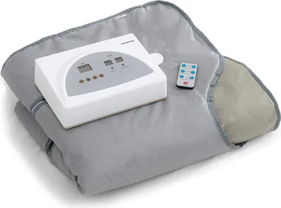 A gray sauna blanket with a white control unit and a remote control.