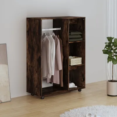 A wardrobe with clothes hanging and shelves with items inside, placed against a wall.