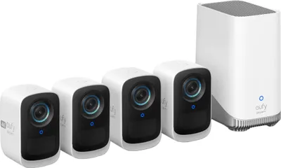 A set of four white eufy security cameras and a white base station are arranged on a white background.