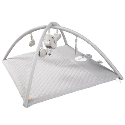 A baby play mat with a play arch and hanging toys.