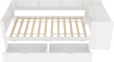 A white wooden bed frame with an open slatted mattress base, two drawers underneath, and a shelf unit at the head. A side unit with shelves is attached to the right.