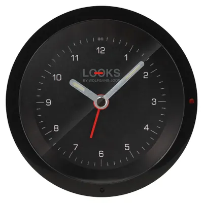 A close-up, front-facing view of a black analog alarm clock with silver hands and red accents.