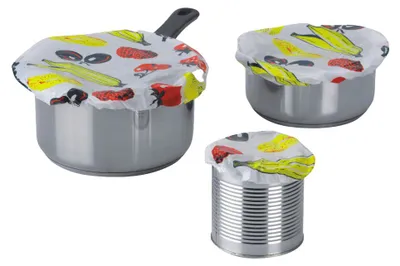 Three different sized containers are covered with reusable food covers featuring a vegetable print.