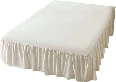 A white bed skirt with ruffles is shown on a bed.