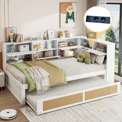 A white daybed with a trundle bed pulled out, set in a bedroom with shelves filled with decorative items and books. A small inset shows a power strip with outlets.