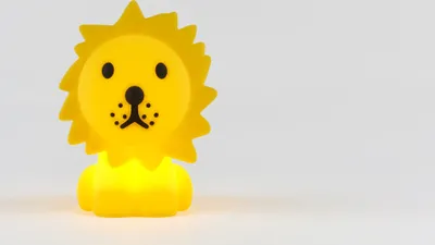 A yellow lion-shaped night light is shown against a plain white background.