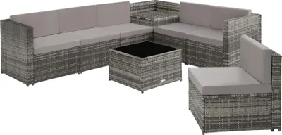 A modular rattan outdoor furniture set with a coffee table.