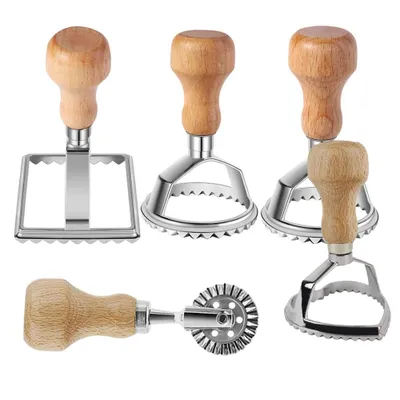 A collection of ravioli cutters with wooden handles against a white background.