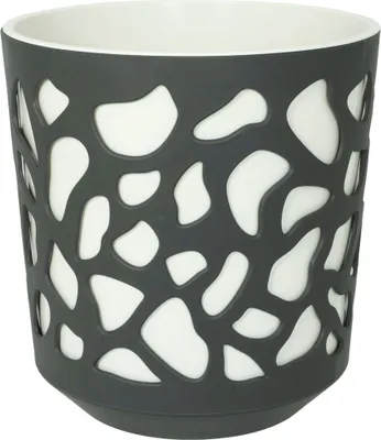 A gray and white planter pot with a cut-out pattern.