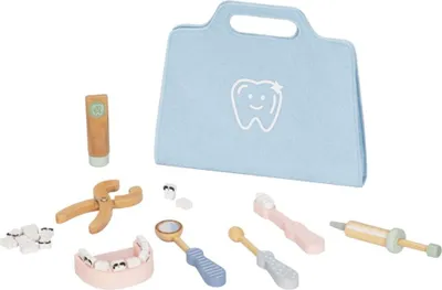 A collection of wooden toy dental instruments and a dental bag are laid out on a white background.