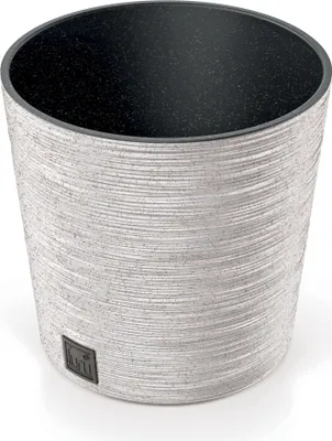 A white textured round planter pot with a black interior.