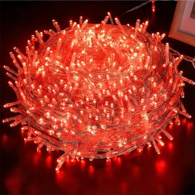 A close-up, tightly wound ball of red LED string lights.