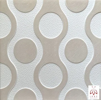 A close-up, textured view of beige and white 3D wall panels with a circular pattern.