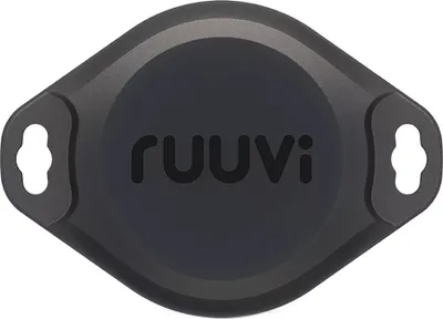 A dark gray, oval-shaped device with a circular central area and two mounting holes on the sides.