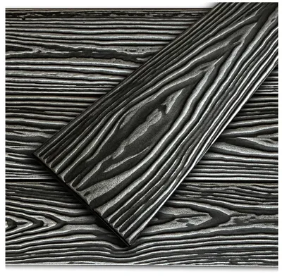 A close-up view of decorative foam panels with a black and silver wood grain texture.