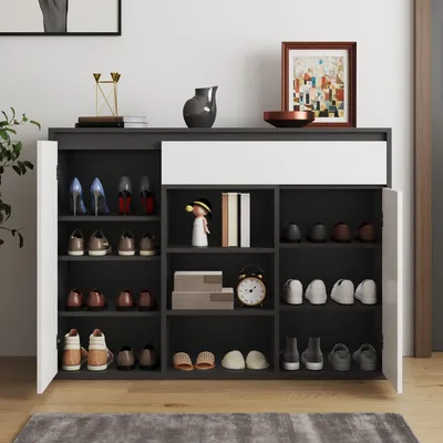 A modern shoe cabinet with multiple shelves and doors, displaying various shoes and decorative items.