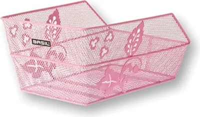 A pink bicycle basket with decorative leaf cutouts.