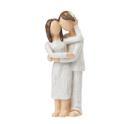 A figurine of a couple embracing.