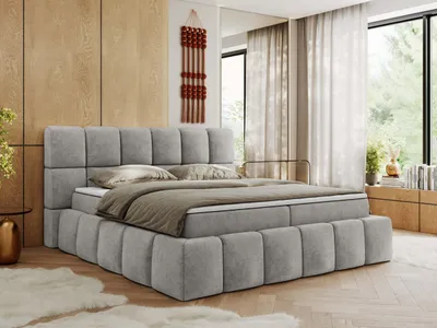 A bedroom setting with a large bed.