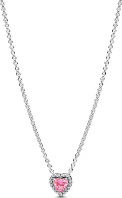 A close-up studio shot of a silver necklace with a pink heart-shaped pendant.
