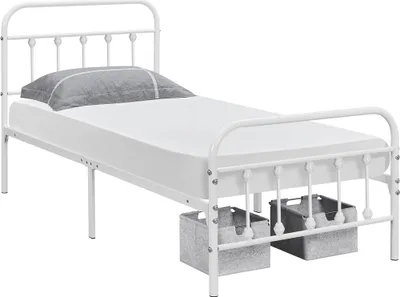 A white metal bed frame with a mattress and a grey pillow, shown from a side angle with two grey storage bins underneath.