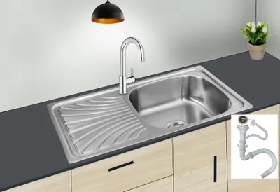 A stainless steel kitchen sink with a faucet and drain assembly is shown on a countertop.