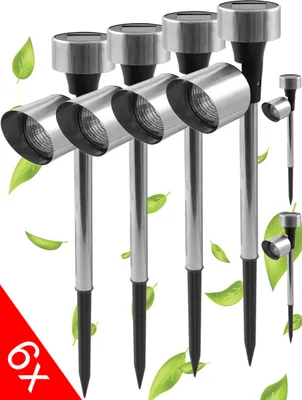 A group of six stainless steel solar-powered garden lights with stakes, surrounded by green leaves.