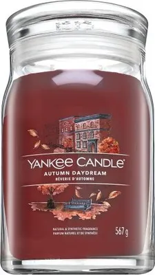 A Yankee Candle Autumn Daydream scented candle in a glass jar with a lid.