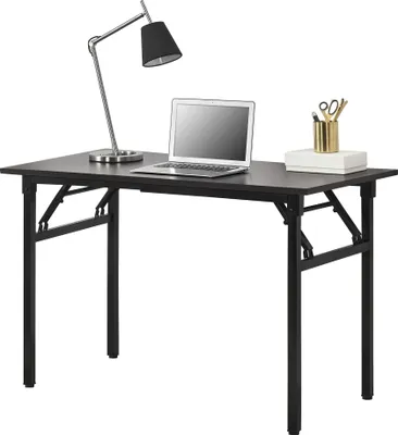 A dark brown folding desk with a laptop, a desk lamp, and a pen holder with scissors.
