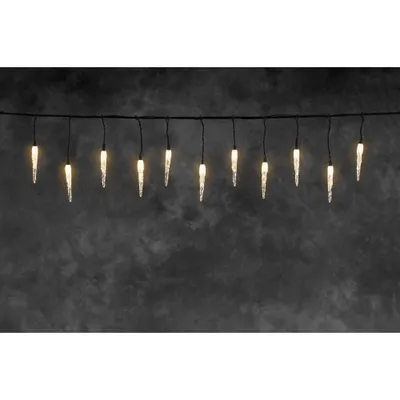 A string of icicle-shaped lights hangs against a dark, textured background.