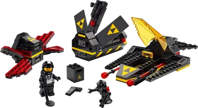 A collection of three LEGO Blacktron spaceships and two minifigures, along with accessories, displayed on a white background.