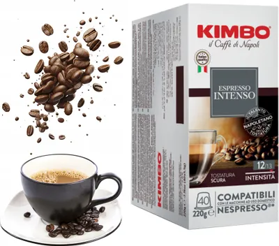 A box of Kimbo Espresso Intenso coffee capsules next to a cup of coffee and scattered coffee beans.