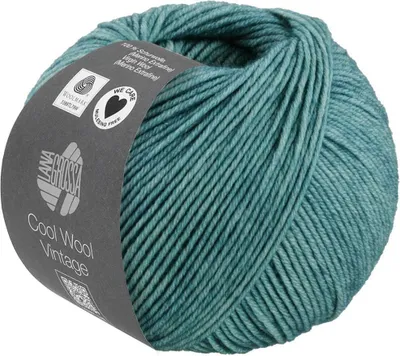 A ball of teal yarn with a label wrapped around it.