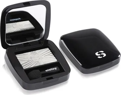 An open black compact with silver eyeshadow and a closed compact next to it.