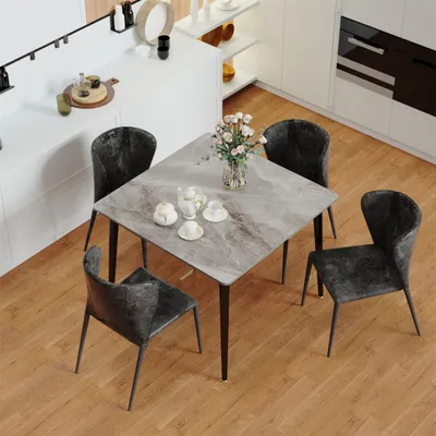 A dining table with four chairs in a modern kitchen setting.