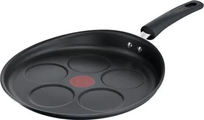 A black pancake pan with five circular indentations and a red heat indicator in the center, set against a white background.