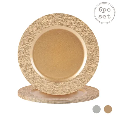 A set of gold charger plates with a textured rim, stacked.